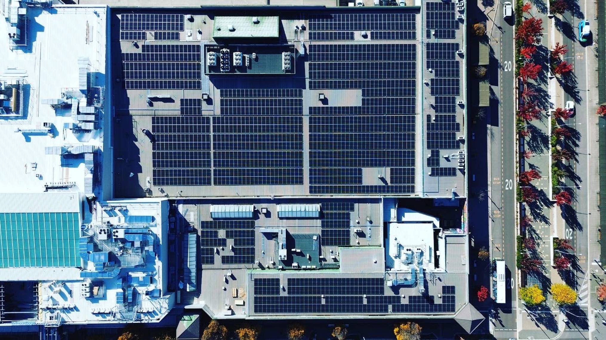 Top-down aerial of a commercial rooftop Solar PV array