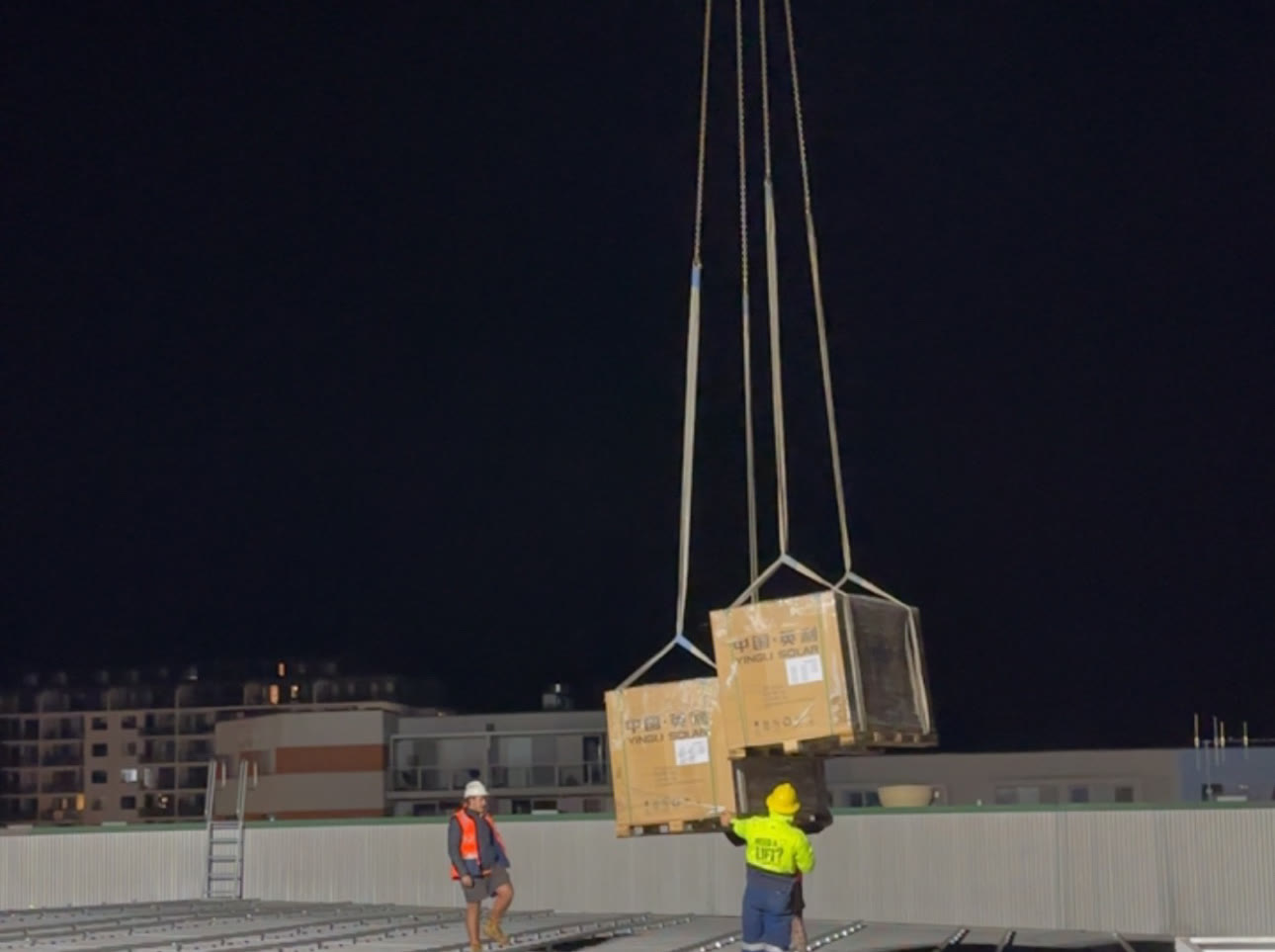 Night crane lift during construction of a commercial energy installation