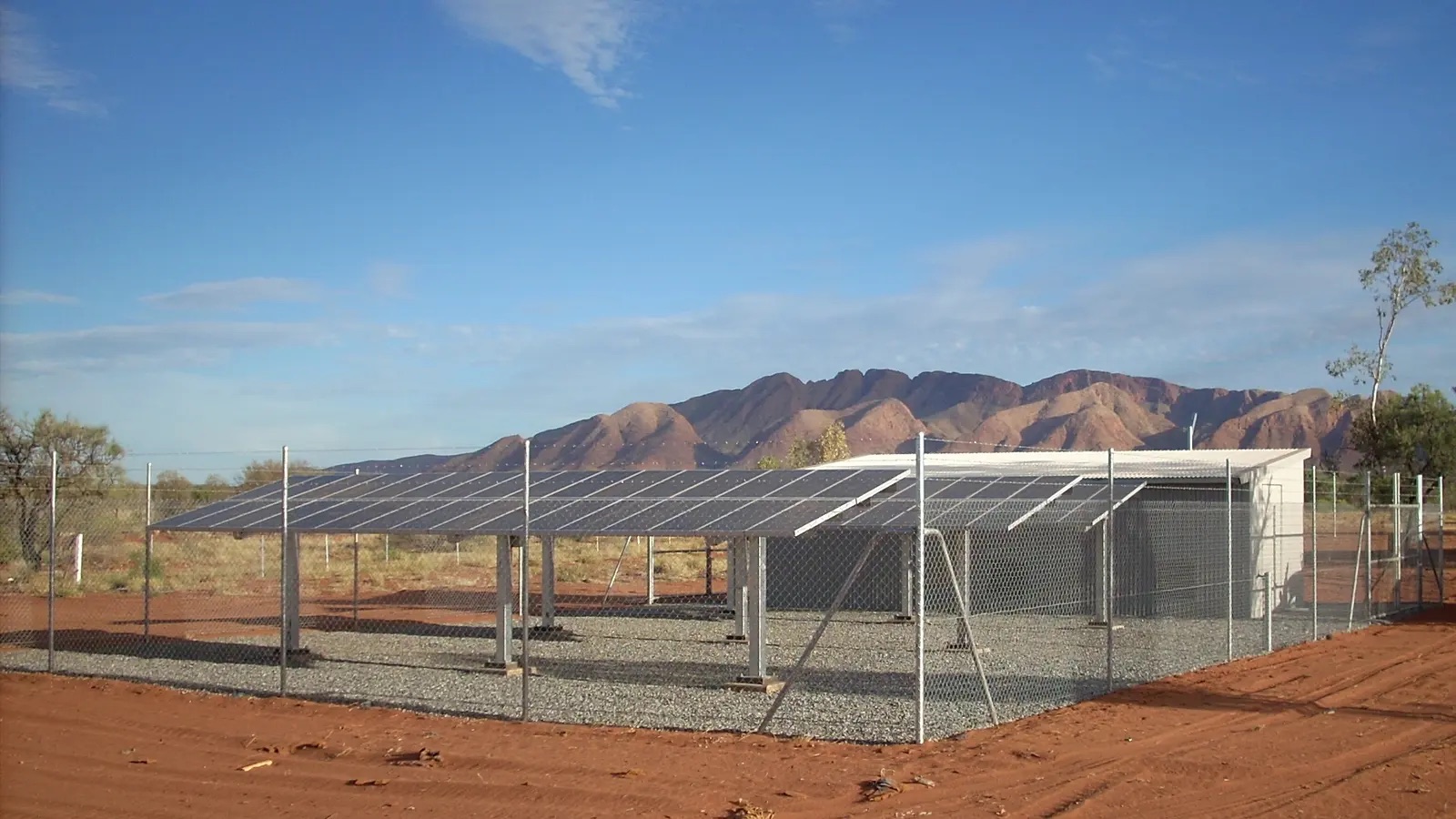 Ground mounted solar array powering a remote homelands community, with the ranges behind it